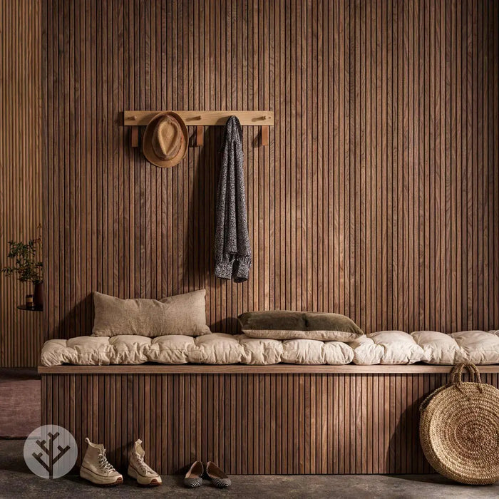 Flutto™ walnut slat wood panels in a modern interior with cozy seating and decor.
